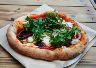 delicious woodfired red onion and rocket pizza