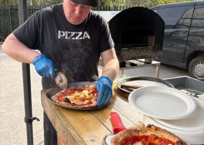 Matthew preparing delicious freshly cooked pizzas
